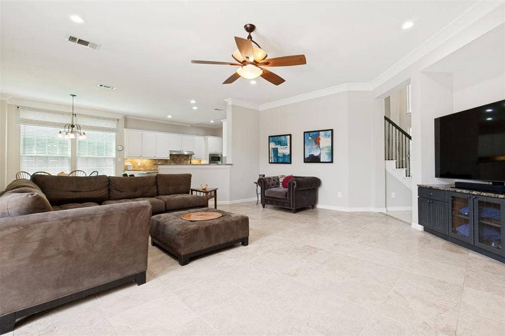 2632 Barrington Drive, Plano, TX 75093 Spacious living area featuring light-toned tile flooring, recessed lighting, and crown molding