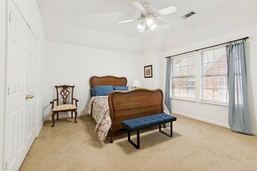 2632 Barrington Drive, Plano, TX 75093 Upstairs bedroom featuring a vaulted ceiling and a ceiling fan with integrated lighting