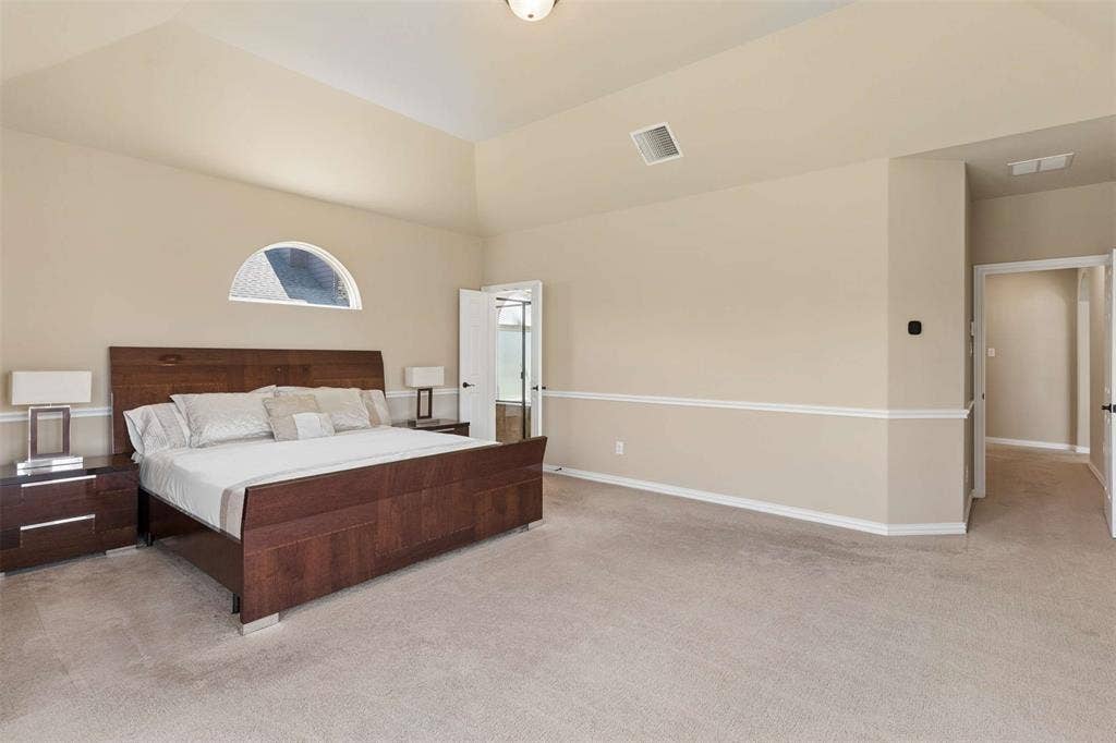 2446 Old Stables Drive, Celina, TX 75009 Bedroom featuring light carpet and vaulted ceiling