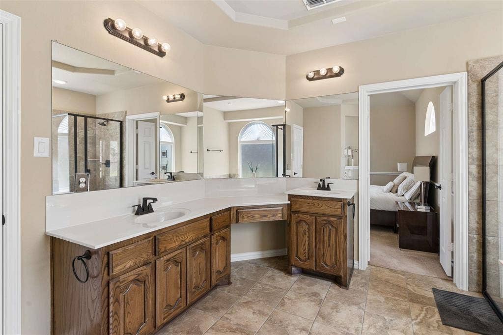 2446 Old Stables Drive, Celina, TX 75009 Bathroom featuring a shower stall, vanity, and ensuite bath