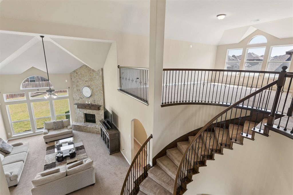 2446 Old Stables Drive, Celina, TX 75009 Living room featuring lofted ceiling, a fireplace, carpet, and ceiling fan