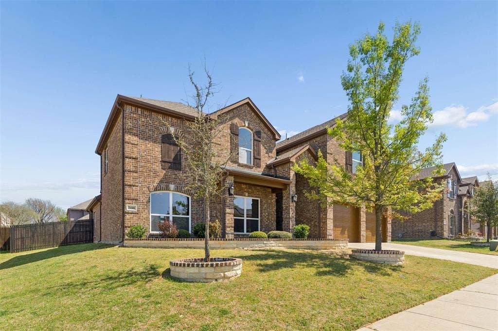 2446 Old Stables Drive, Celina, TX 75009 Traditional home with brick siding, driveway, and a garage
