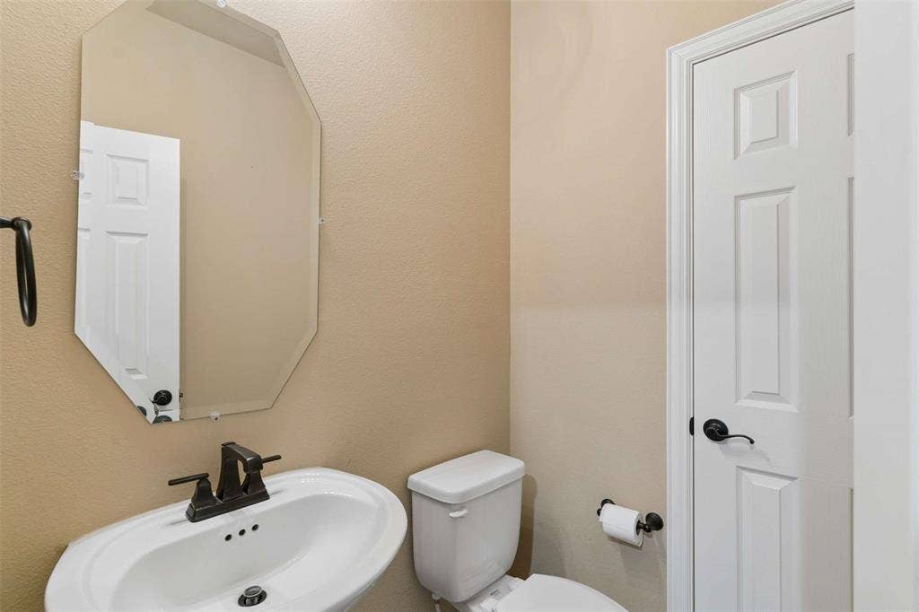 2446 Old Stables Drive, Celina, TX 75009 Half bathroom featuring a textured wall