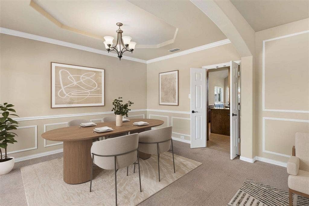 2446 Old Stables Drive, Celina, TX 75009 Formal dining area with tray ceiling, crown molding, and wainscoting
