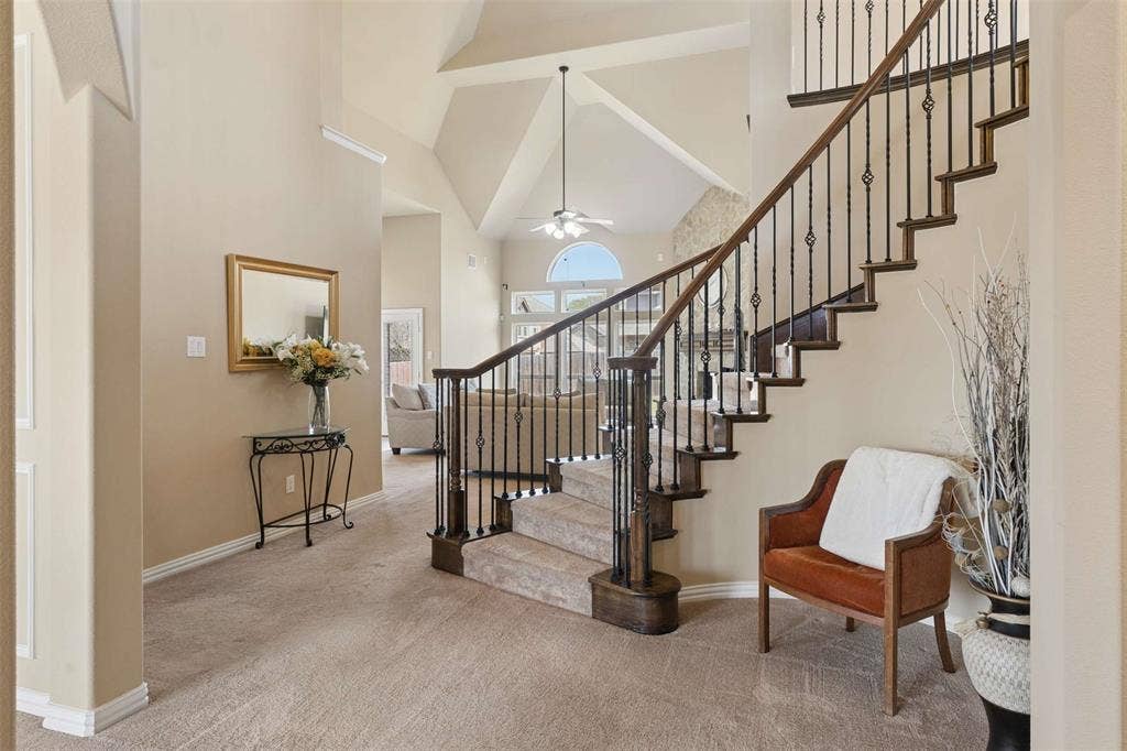 2446 Old Stables Drive, Celina, TX 75009 Stairway featuring a high ceiling, carpet, and ceiling fan