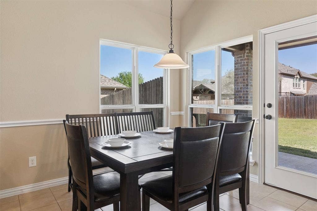 2446 Old Stables Drive, Celina, TX 75009 Dining space featuring vaulted ceiling and light tile patterned flooring