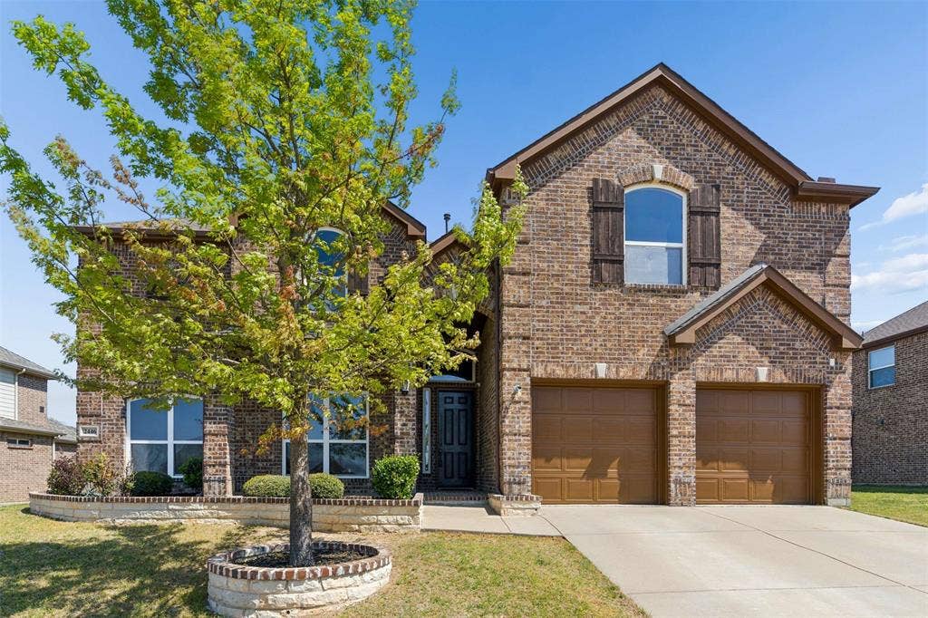 2446 Old Stables Drive, Celina, TX 75009 View of front of home featuring brick siding, a garage, concrete driveway, and a front yard