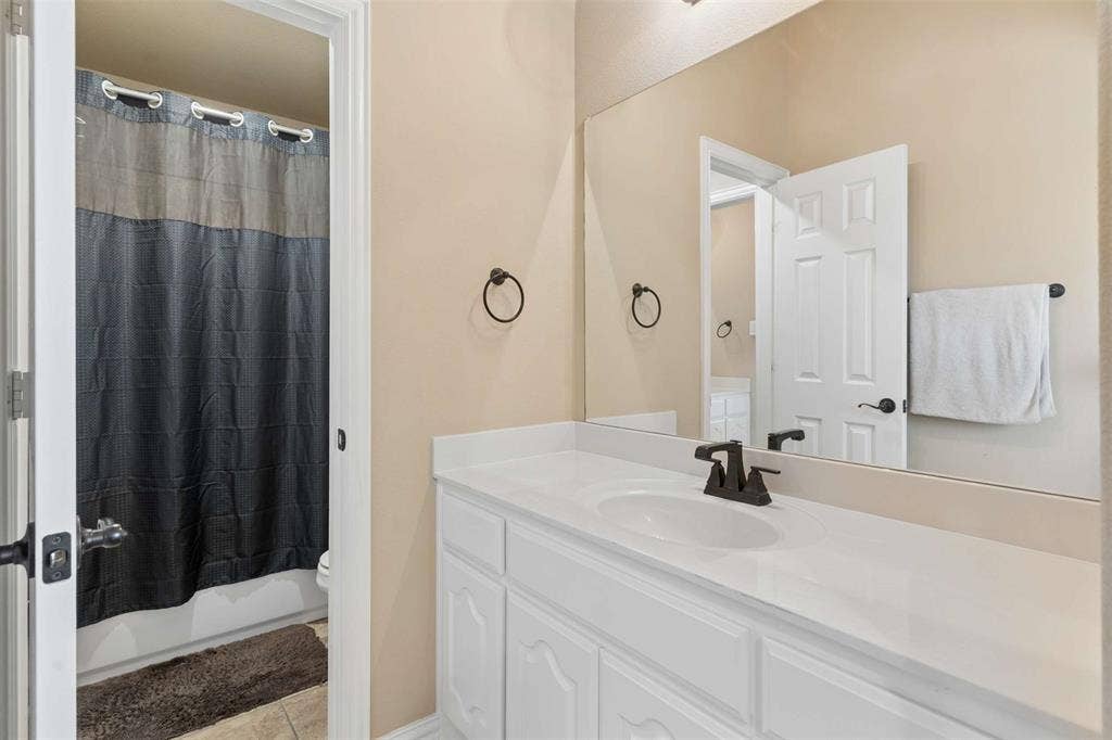 2446 Old Stables Drive, Celina, TX 75009 Bathroom with vanity, light tile patterned floors, and shower / tub combo with curtain