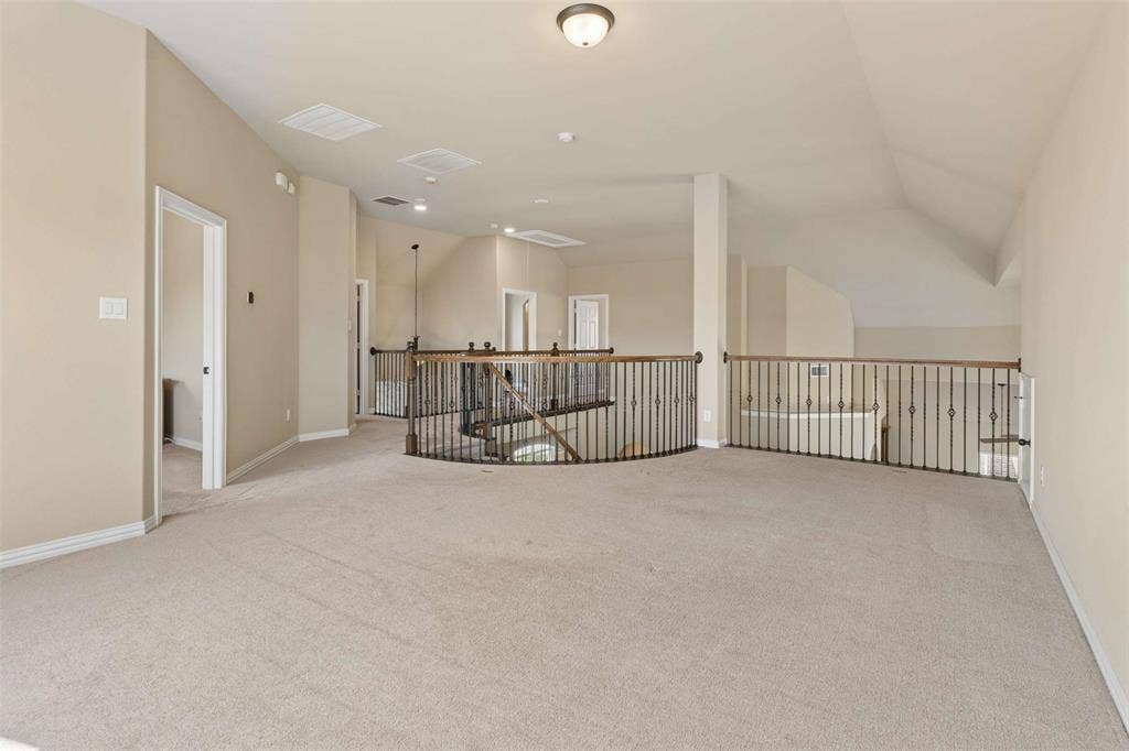 2446 Old Stables Drive, Celina, TX 75009 Unfurnished room with light colored carpet and vaulted ceiling