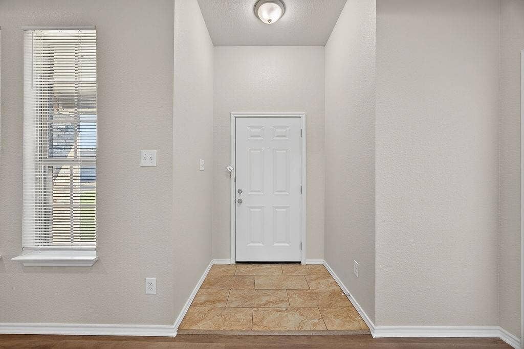 625 Green Mound Drive, Glenn Heights, TX 75154 Doorway to outside featuring baseboards