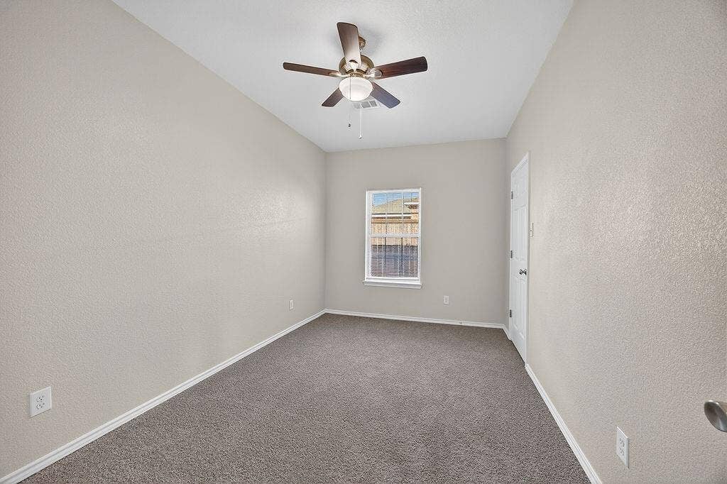 625 Green Mound Drive, Glenn Heights, TX 75154 Spare room featuring a ceiling fan, carpet flooring, and a textured wall