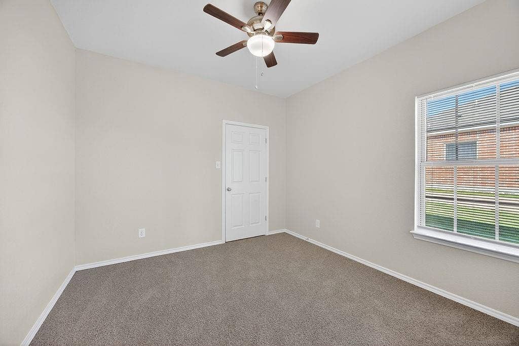 625 Green Mound Drive, Glenn Heights, TX 75154 Spare room with dark colored carpet and a ceiling fan