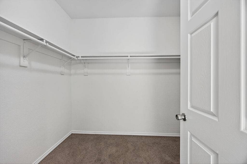 625 Green Mound Drive, Glenn Heights, TX 75154 Walk in closet with dark colored carpet