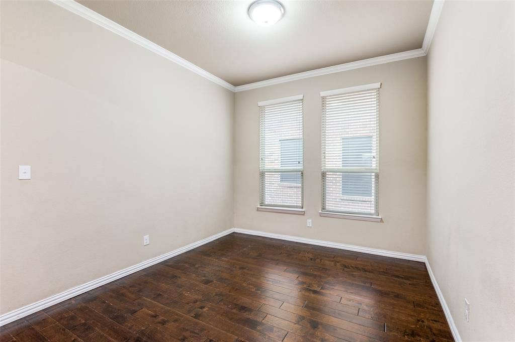 16425 Toledo Bend Court, Prosper, TX 75078 Unfurnished room with dark wood finished floors and crown molding