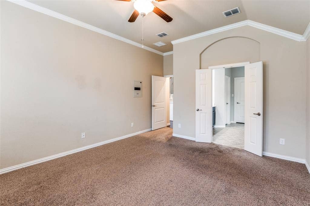 16425 Toledo Bend Court, Prosper, TX 75078 Unfurnished bedroom featuring ornamental molding, carpet, and a ceiling fan