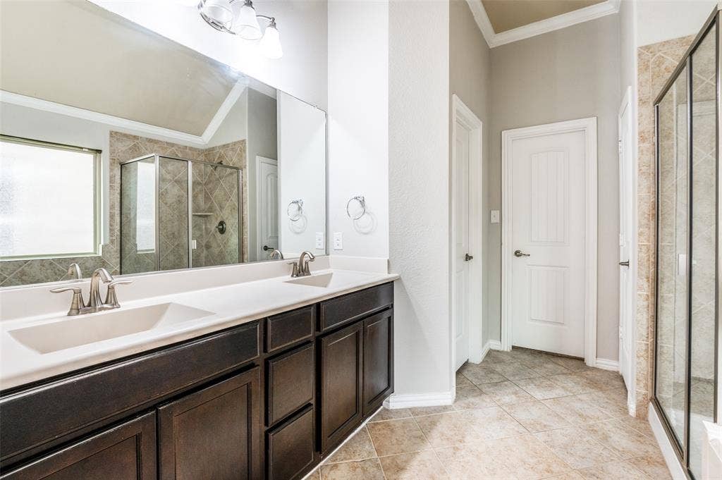 16425 Toledo Bend Court, Prosper, TX 75078 Full bathroom with ornamental molding, double vanity, a stall shower, and light tile patterned floors