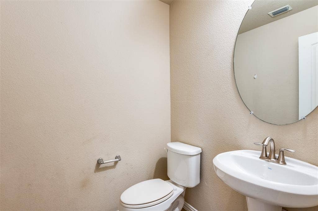 16425 Toledo Bend Court, Prosper, TX 75078 Bathroom featuring toilet and a textured wall