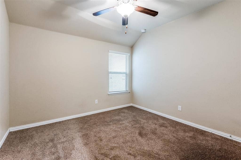 16425 Toledo Bend Court, Prosper, TX 75078 Unfurnished room with a ceiling fan, lofted ceiling, and dark colored carpet