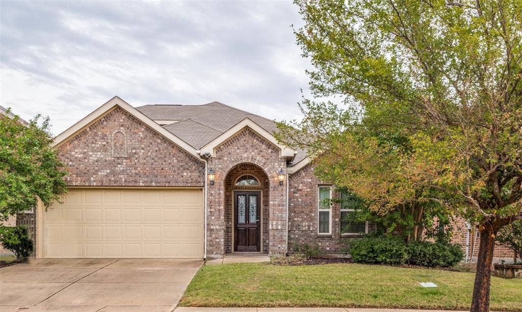 16425 Toledo Bend Court, Prosper, TX 75078 View of front of property featuring an attached garage, brick siding, driveway, a front yard, and roof with shingles