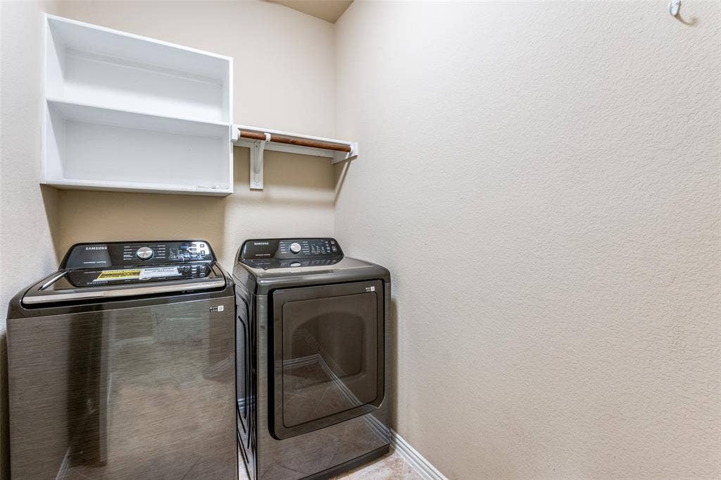 16425 Toledo Bend Court, Prosper, TX 75078 Laundry room featuring washing machine and clothes dryer and a textured wall