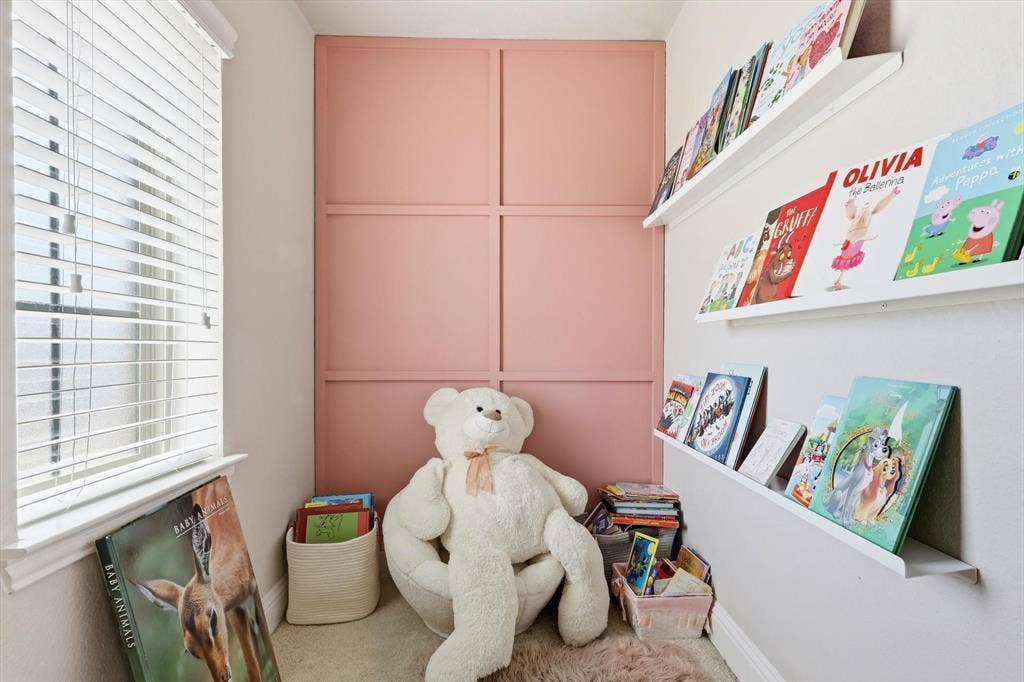 1212 Mount Olive Lane, Forney, TX 75126 Reading nook off bedroom #3 w/ paneled accent wall, white window blinds, and built-in floating book shelves