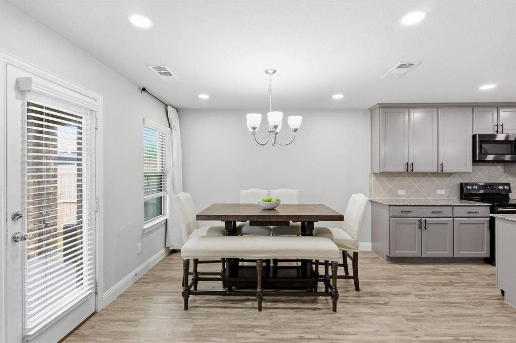1212 Mount Olive Lane, Forney, TX 75126 Open-concept dining area featuring wood-finish flooring, recessed lighting, and a modern chandelier