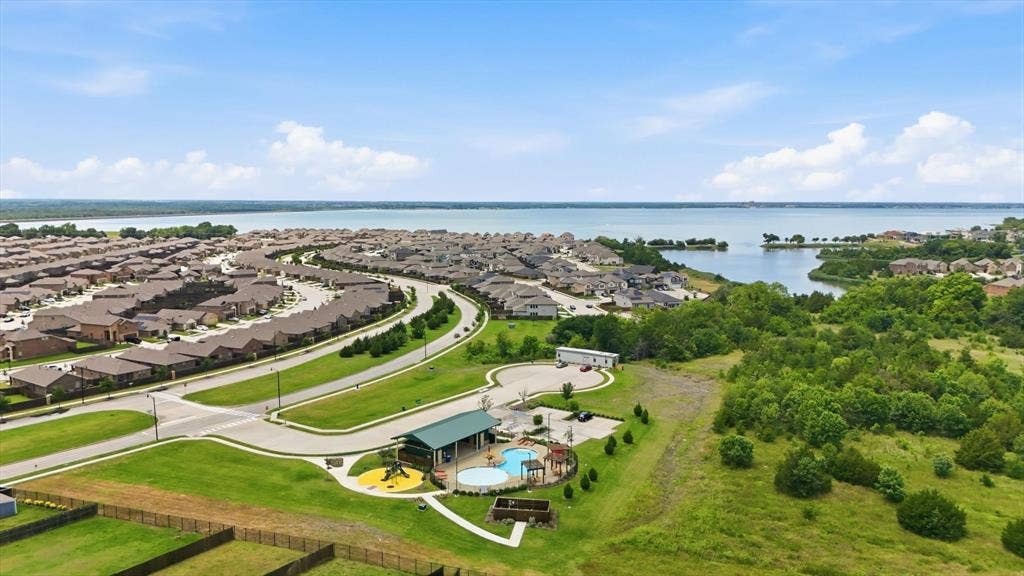 1212 Mount Olive Lane, Forney, TX 75126 Pool #2, brand new, with playground and shallow end for kids. Just steps from beautiful Lake Ray Hubbard fishing access. Future plans include a walking path down to the water.