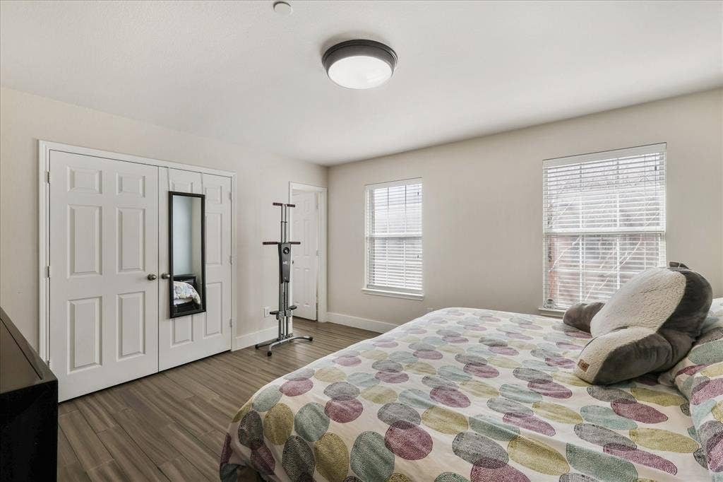3025 Stone Forest Circle, McKinney, TX 75070 Bedroom featuring dark wood-type flooring and a closet