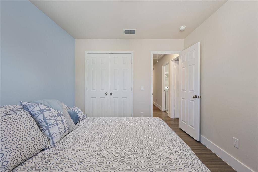 3025 Stone Forest Circle, McKinney, TX 75070 Bedroom featuring dark wood-type flooring and a closet