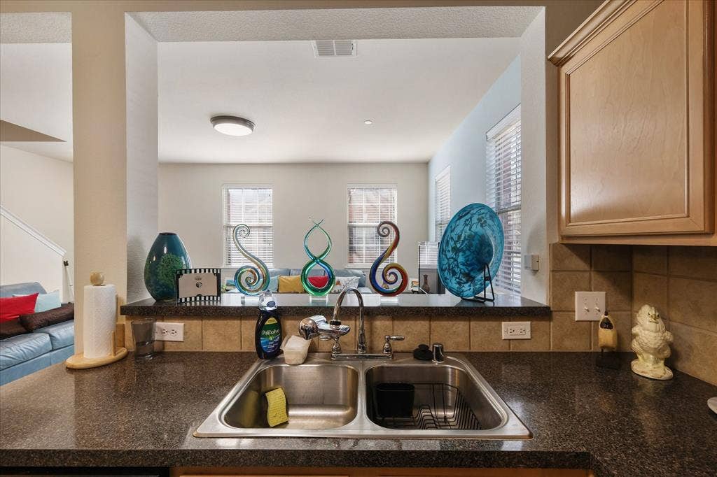 3025 Stone Forest Circle, McKinney, TX 75070 Kitchen featuring a sink and tasteful backsplash