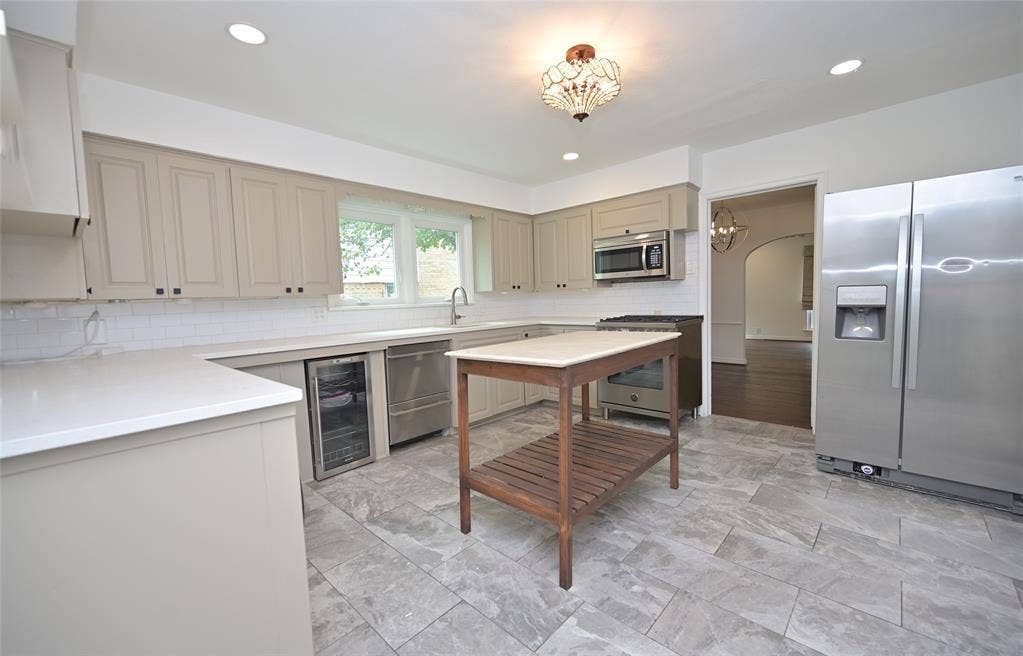 Kitchen with updated cabinets and solid surface countertops