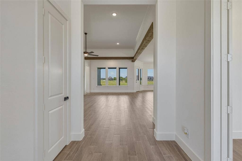 2408 Quartz Street, Krum, TX 76249 An open concept interior featuring wood-finish flooring, high ceilings, recessed lighting, and exposed ceiling beams