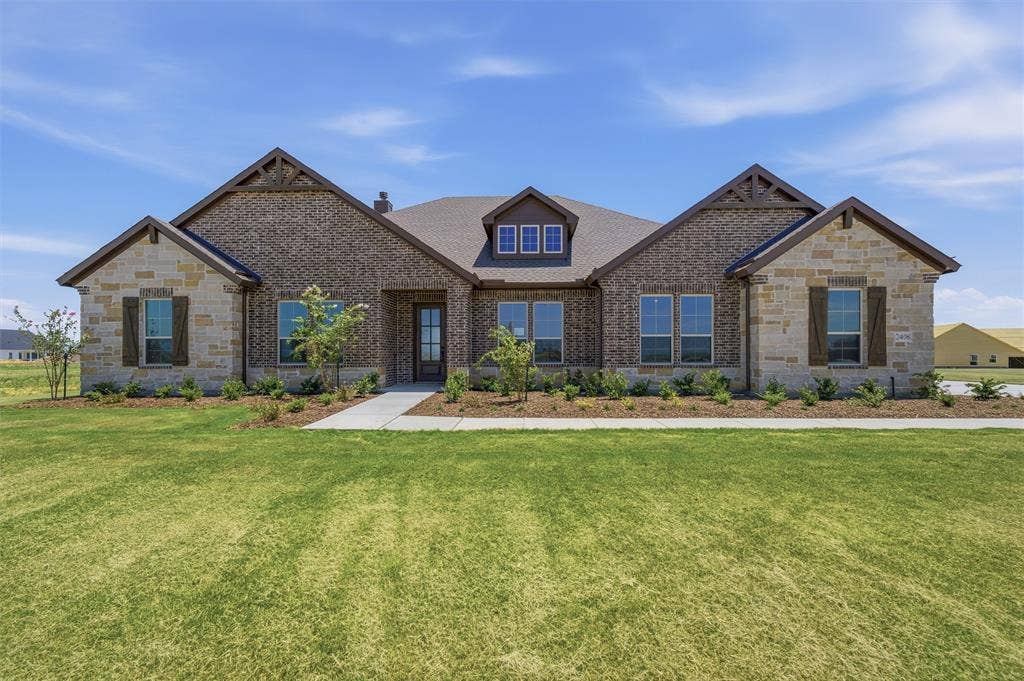 2408 Quartz Street, Krum, TX 76249 Contemporary exterior featuring a brick and stone facade with wood-look shutters