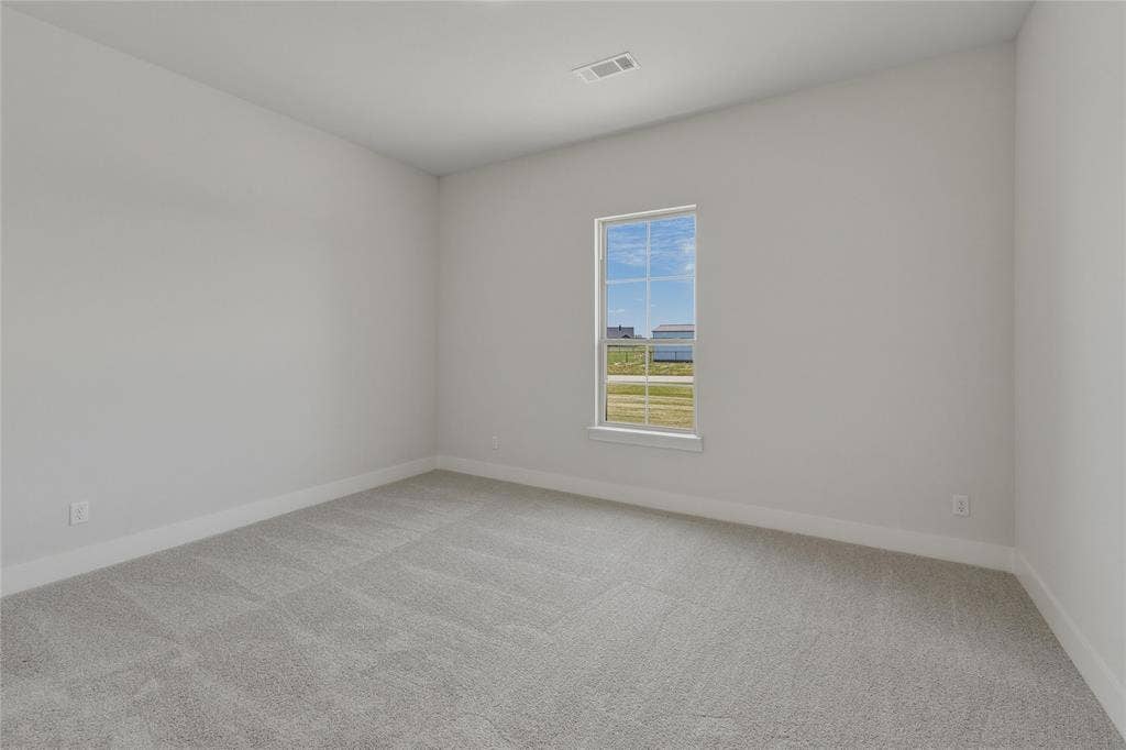 2305 Gypsum Street, Krum, TX 76249 Neutral wall tones complemented by patterned carpeting