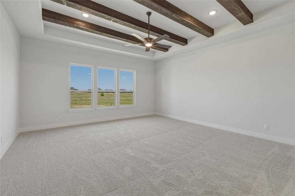 2305 Gypsum Street, Krum, TX 76249 Spacious room featuring a tray ceiling with exposed wood beams and recessed lighting