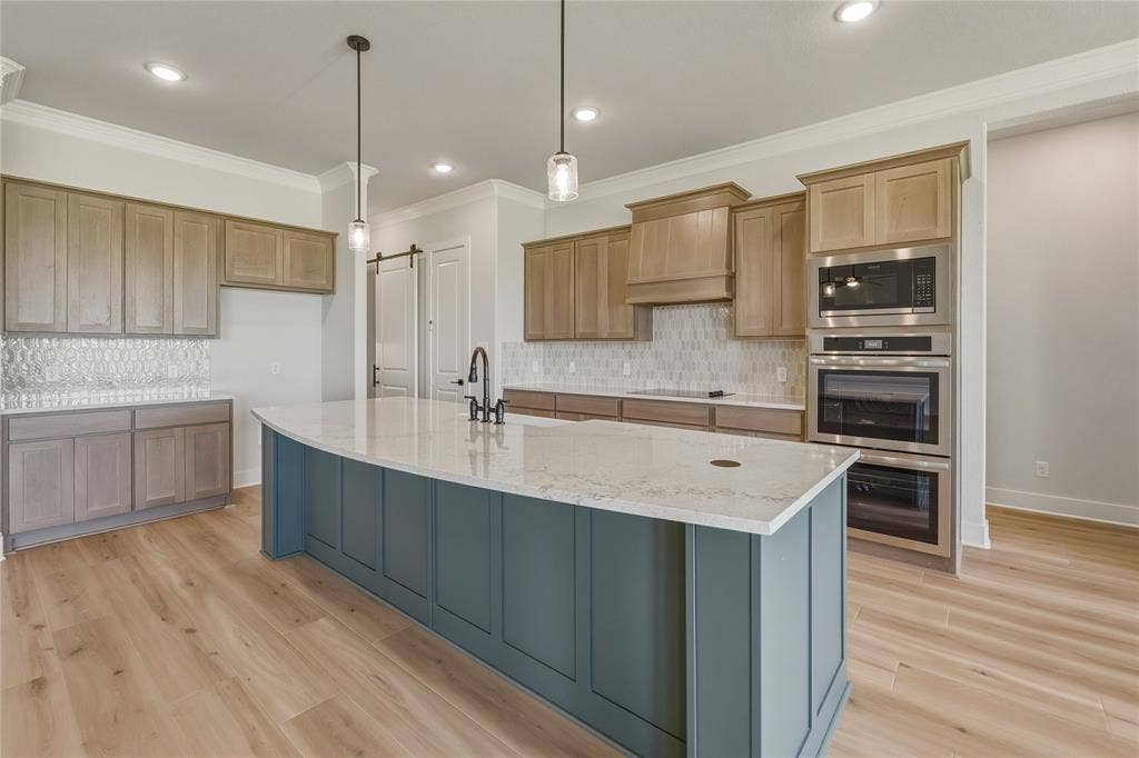 2305 Gypsum Street, Krum, TX 76249 Central kitchen island with a quartz countertop and integrated sink