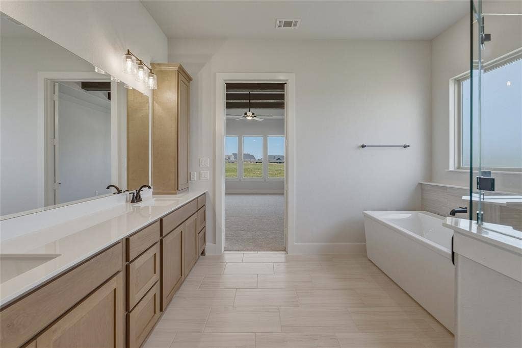 2305 Gypsum Street, Krum, TX 76249 Bathroom featuring a dual vanity with light wood-finish cabinetry and white countertops