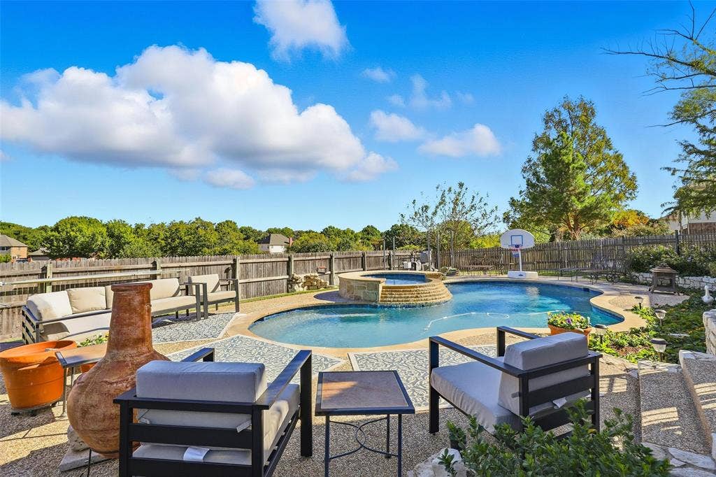 5212 Whisper Drive, Fort Worth, TX 76123 Integrated pool / spa with a patio area, an outdoor hangout area, and a fenced backyard