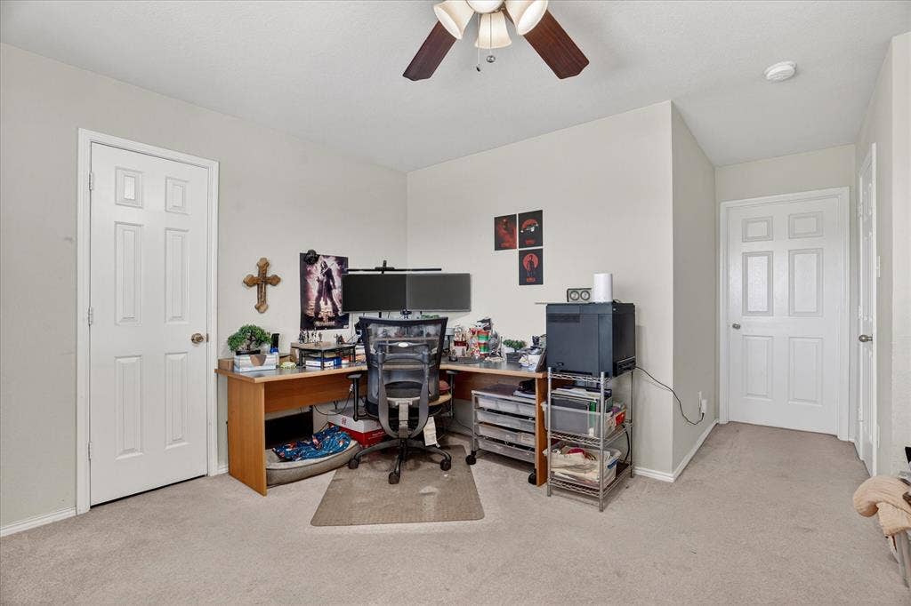 5212 Whisper Drive, Fort Worth, TX 76123 Carpeted room featuring a ceiling fan with integrated lighting, neutral wall tones, and white paneled doors