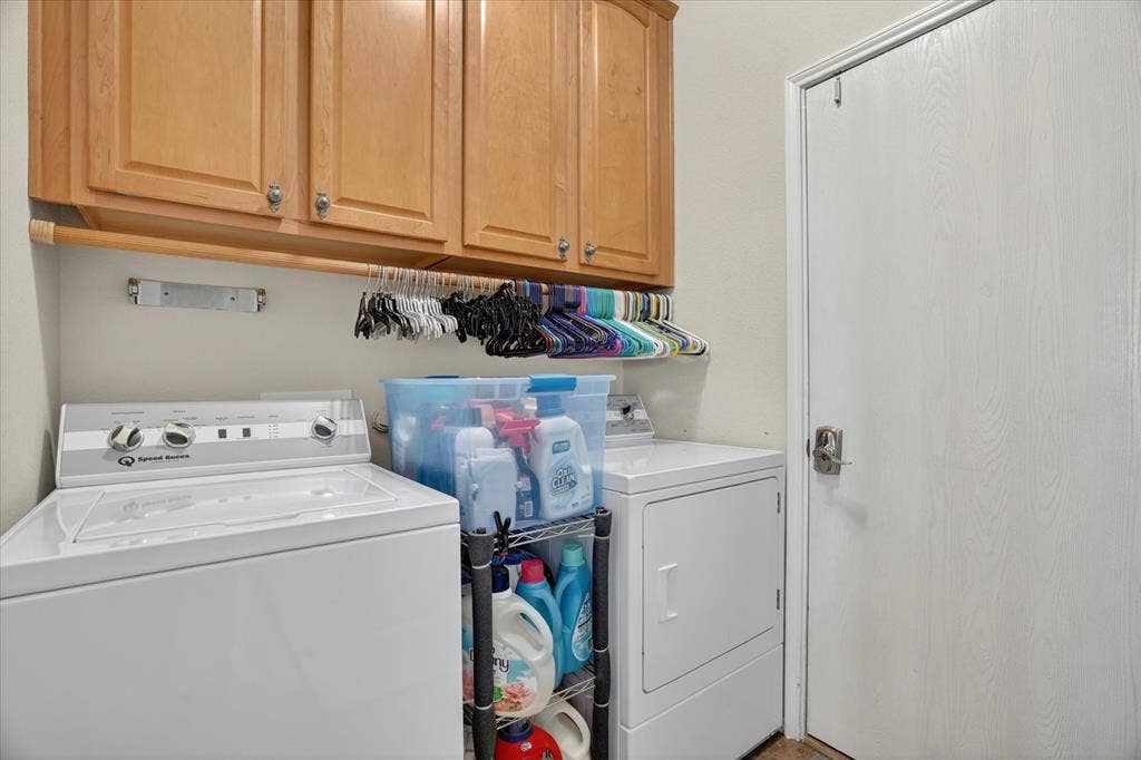 5212 Whisper Drive, Fort Worth, TX 76123 Laundry area featuring light wood cabinetry, a hanging rod, and a white interior door