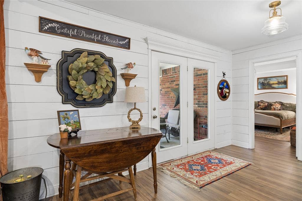 25 Starview Drive, Star Harbor, TX 75148 Foyer featuring french doors, wood finished floors, and wood walls