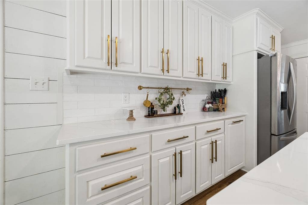 25 Starview Drive, Star Harbor, TX 75148 Kitchen with white cabinets, stainless steel fridge, light stone countertops, and backsplash