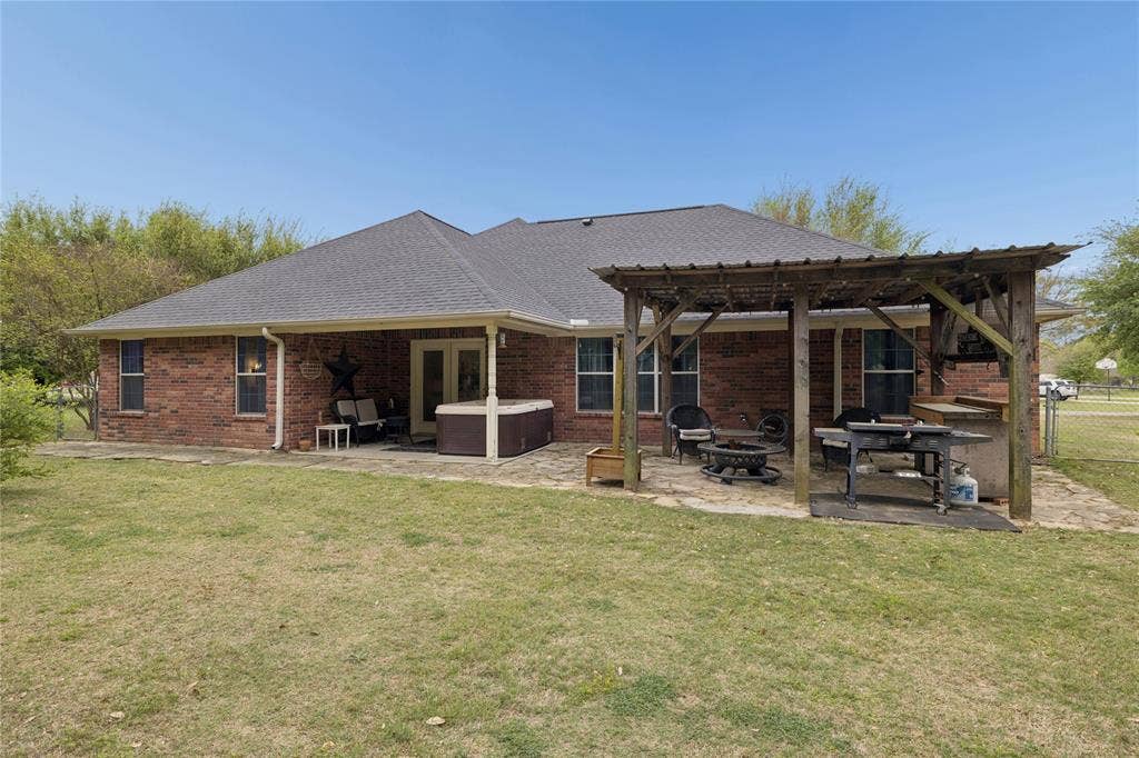 25 Starview Drive, Star Harbor, TX 75148 Back of house with a patio area, brick siding, a pergola, a hot tub