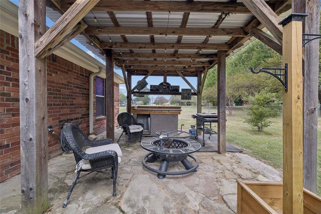 25 Starview Drive, Star Harbor, TX 75148 View of patio / terrace featuring an outdoor fire pit