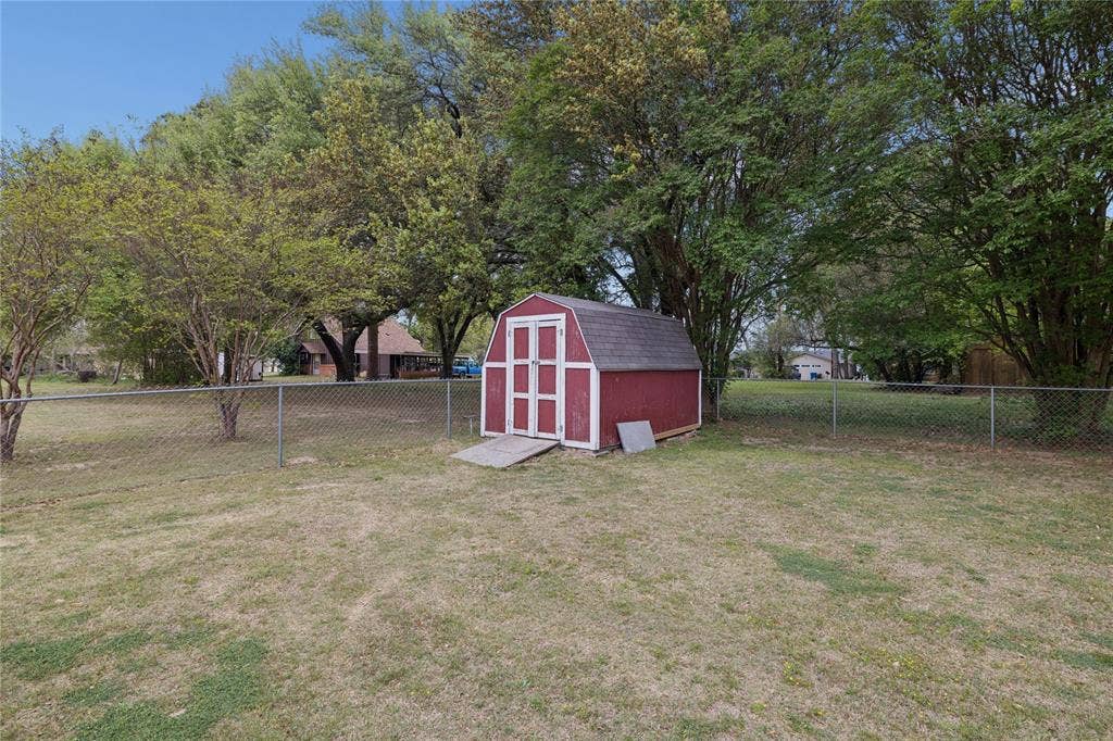 25 Starview Drive, Star Harbor, TX 75148 Fenced backyard featuring a storage shed
