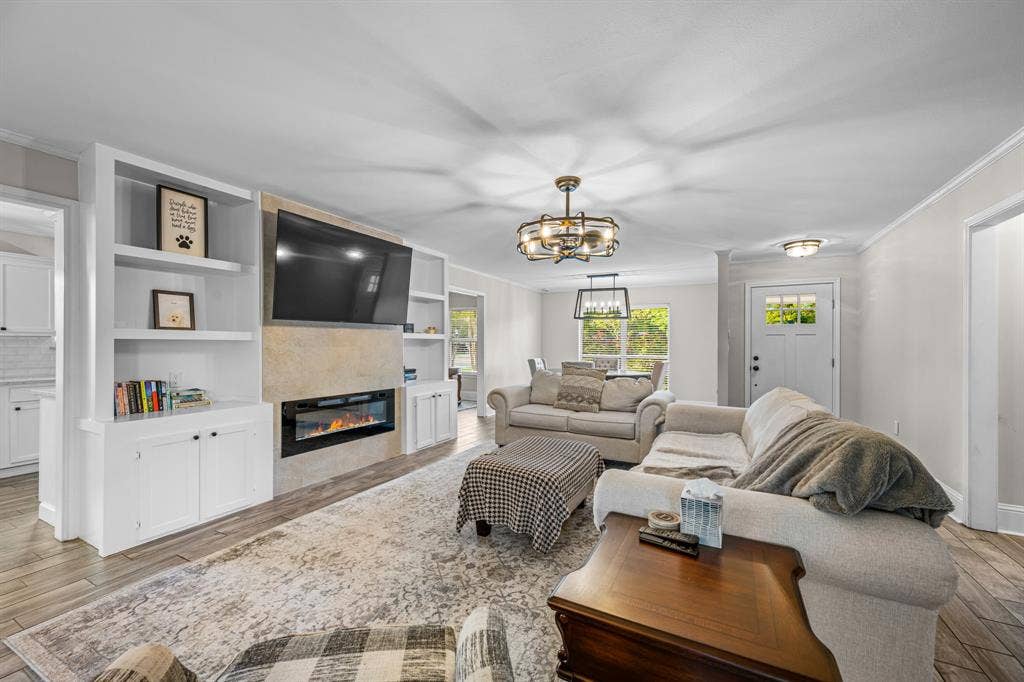 Living room featuring beautiful built ins and an electric fireplace