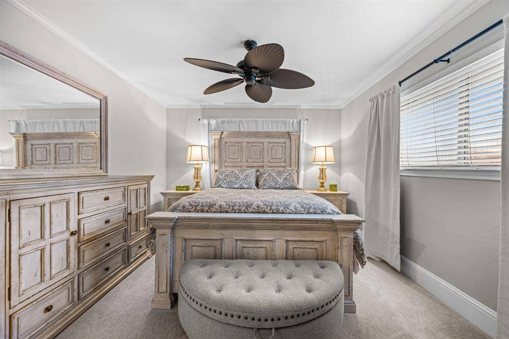 The primary bedroom has a ceiling fan and great natural light.