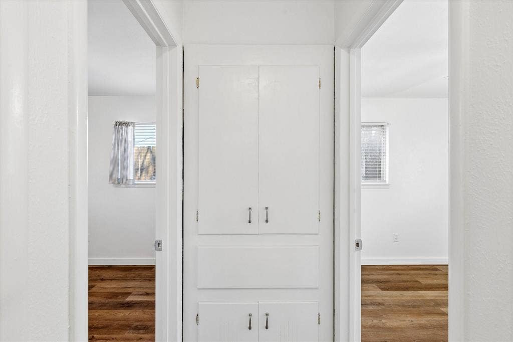 5820 Shipp Drive, Watauga, TX 76148 Hallway storage with white built-in cabinetry and wood-finish flooring