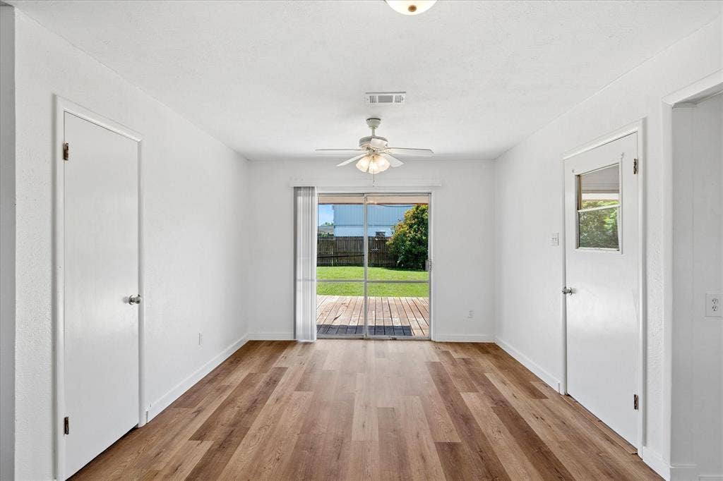 5820 Shipp Drive, Watauga, TX 76148 Interior space featuring wood-finish flooring, white walls, and a ceiling fan