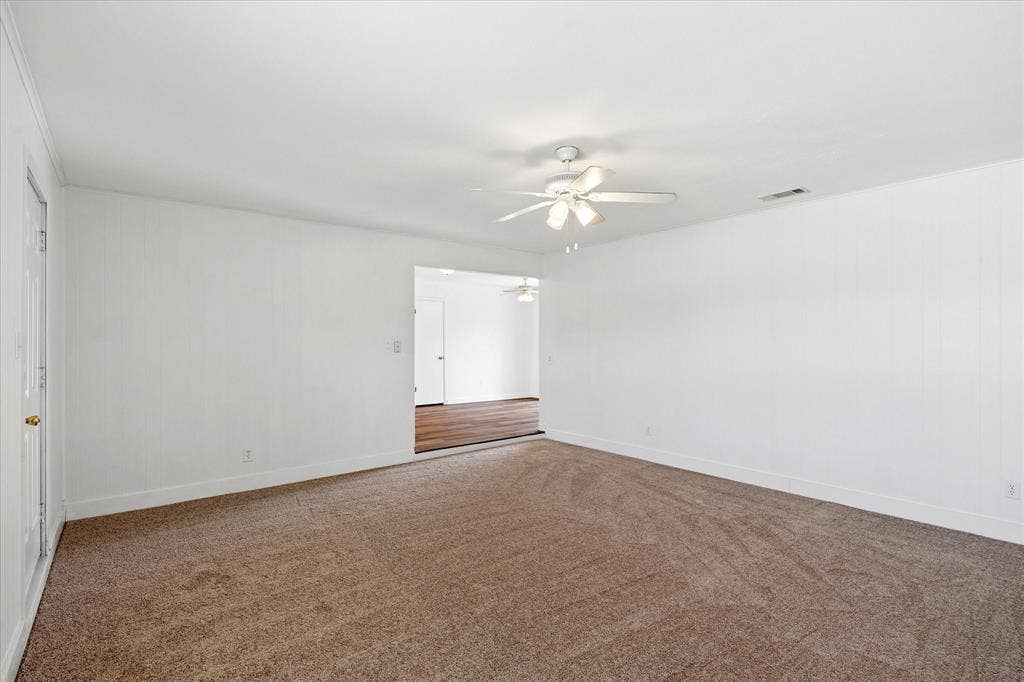 5820 Shipp Drive, Watauga, TX 76148 Spacious room featuring neutral carpeting and white painted walls